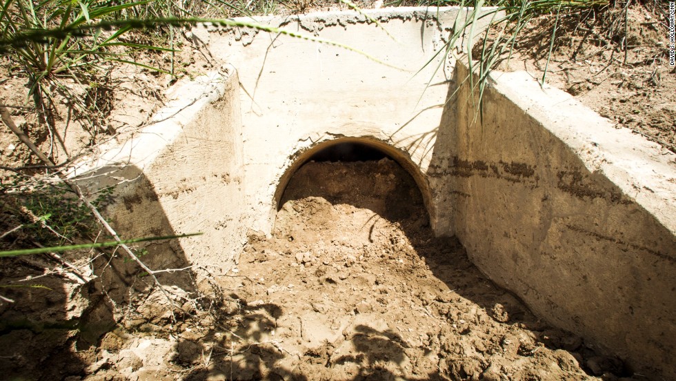 A storm drain in Mission, Texas is filled with soil and rocks in an effort to keep people from hiding in it. 