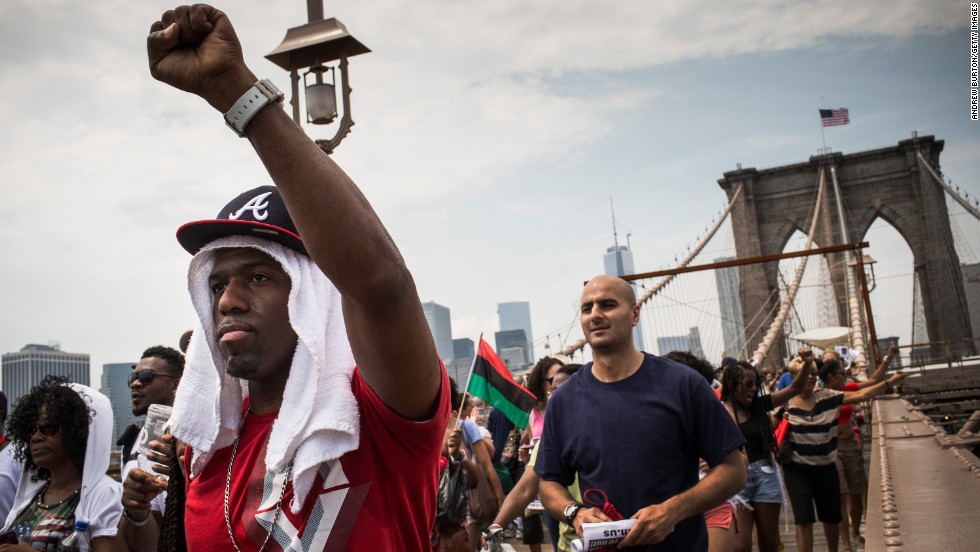 Protesters march across the Brooklyn Bridge toward Brooklyn after attending the rally in Manhattan on July 20.