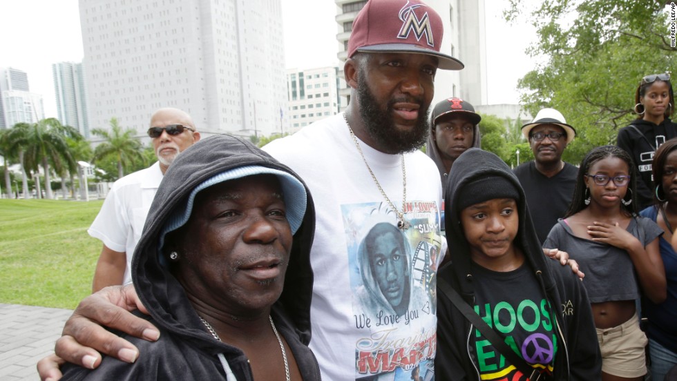 Tracy Martin, father of Trayvon Martin, poses for a photo with supporters wearing hoodies at the rally in Miami on July 20.