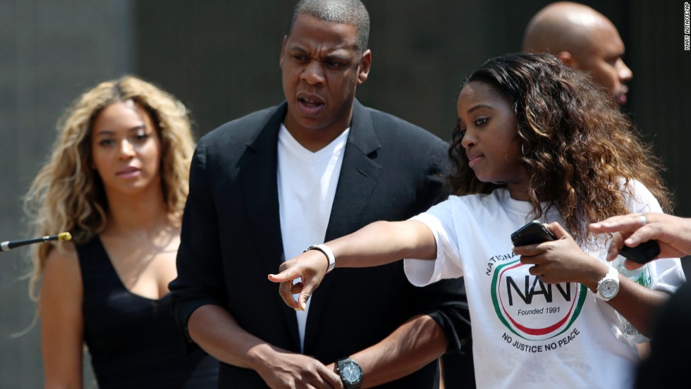 Beyoncé, left, and Jay-Z, center, arrive at the rally in New York City on July 20.