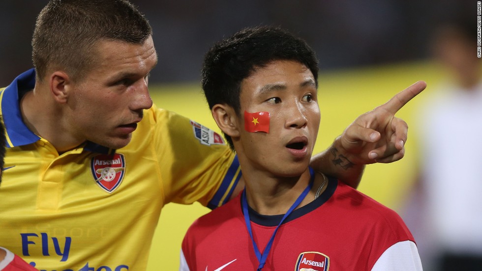 Vu Xuan Tien became Arsenal&#39;s unofficial mascot on the Hanoi leg of their pre-season Asia tour after he ran alongside the team&#39;s coach for several miles. Tien was then invited to lead the Arsenal players onto the pitch at the My Dinh stadium in Hanoi before their match against the Vietnamese national team, which they won 7-1.