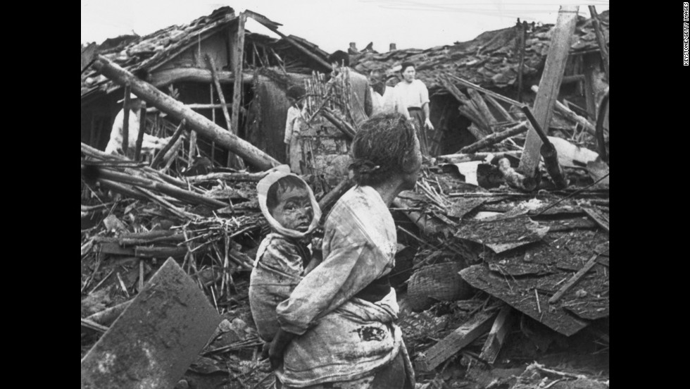 A woman and child wander among debris in Pyongyang, North Korea, after an air raid by U.S. planes, circa 1950. The war began on June 25, 1950, when the North Korean People&#39;s Army crossed the 38th parallel and easily overwhelmed South Korean forces in a surprise attack. 