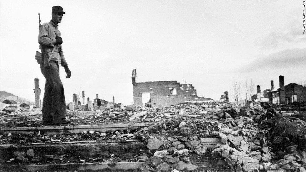 An American soldier walks around the rubble of Hamhung, Korea, circa 1950.