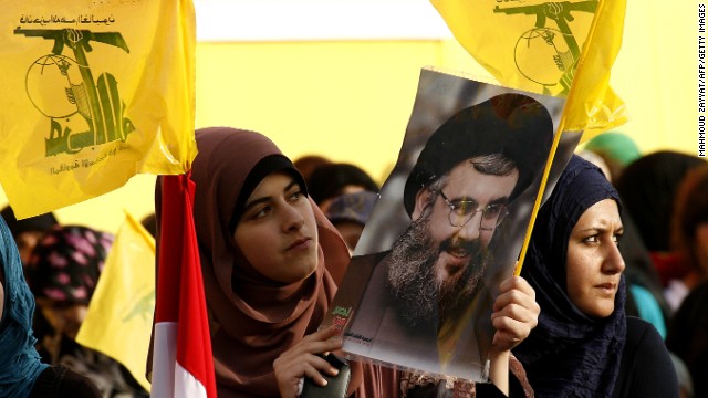 Women hold Hezbollah flags and a picture of the movement&#39;s chief, Hassan Nasrallah, in Lebanon on May 25.