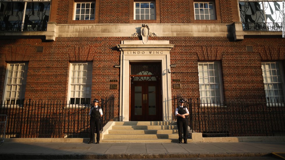 Police guard the Lindo Wing at St. Mary&#39;s Hospital in London as crowds gather and await news of the birth of the first child of the Duke and Duchess of Cambridge on July 22.