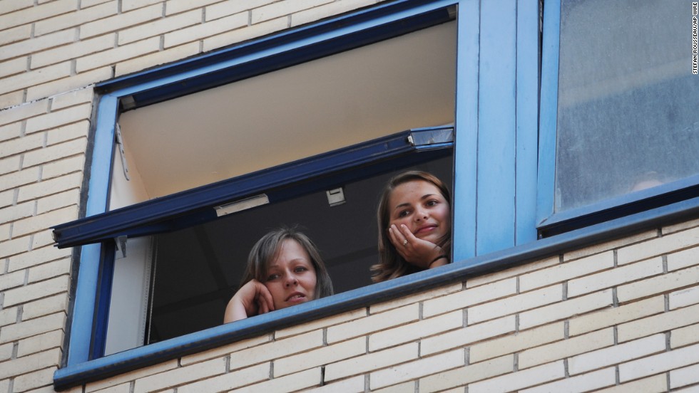 Hospital staff look out over a gathering crowd at St. Mary&#39;s Hospital in London on July 22.