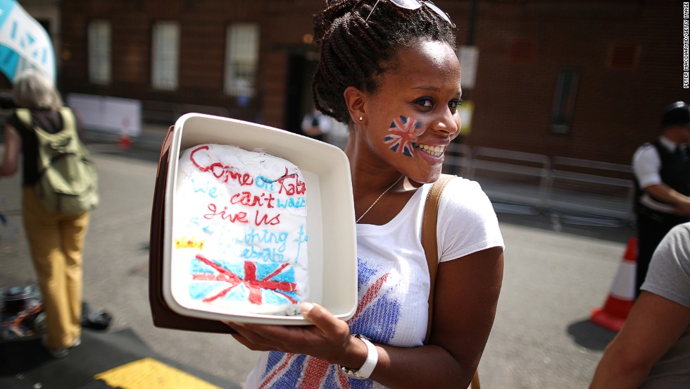 Royal fan Teba Diatta stands outside St. Mary&#39;s Hospital with a cake decorated for the occasion on July 22.