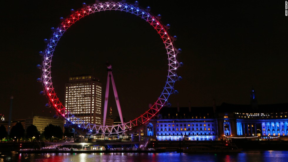 The London Eye Ferris wheel on the banks of the Thames is lit up in red, blue and white to mark the birth of the boy on July 22.