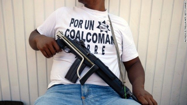 An armed man - member of a vigilante group - keeps watch in Coalcoman community, in Michoacan State, Mexico, on May 22, 2013. Vigilante groups, calling themselves 'community police', have sprung up this year in western and southern Mexican towns, in an effort to combat drug-related violence. AFP PHOTO/Alfredo Estrella (Photo credit should read ALFREDO ESTRELLA/AFP/Getty Images)