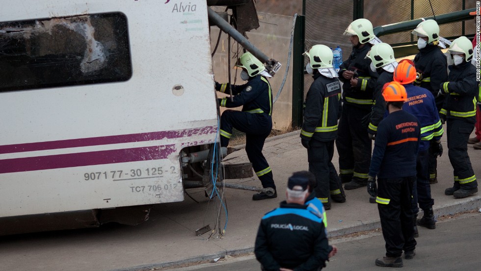 Emergency personnel work at the crash scene July 25. An investigation into the cause of the derailment is under way.