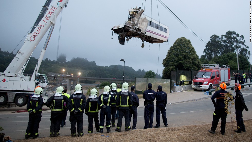 A train car is lifted Thursday, July 25, at Angrois near Santiago de Compostela, Spain. The train derailed as it hurtled around a curve at high speed on Wednesday, July 24.