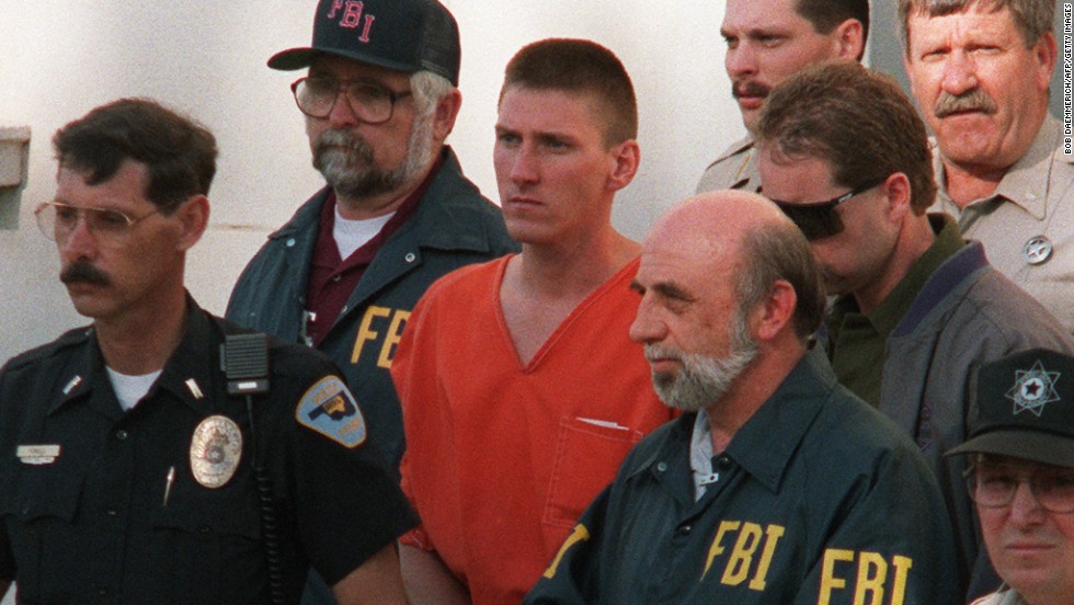 Timothy McVeigh is led from a courthouse in Perry, Oklahoma, after being charged in connection with the bombing. Two years later, he was convicted on 11 counts of murder, conspiracy and using a weapon of mass destruction. He was executed by lethal injection in 2001. His co-conspirator, Terry Nichols, was sentenced to life in prison. Both McVeigh and Nichols were former U.S. Army soldiers associated with the extreme right-wing Patriot Movement. The Patriot Movement rejects the legitimacy of the federal government and law enforcement.