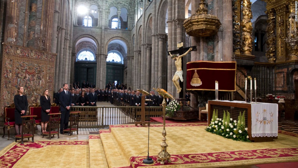 Spain&#39;s Princess Elena, left, Princess Letizia and Prince Felipe attend &lt;a href=&quot;http://www.cnn.com/2013/07/29/world/europe/spain-train-crash/index.html&quot;&gt;a funeral Mass for the victims of a train&lt;/a&gt; derailment at a cathedral in Santiago de Compostela on Monday July 29. At least 79 people have been confirmed dead in the July 24 crash in northwest Spain.