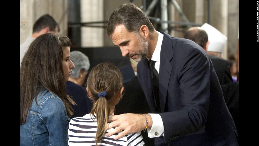 Prince Felipe expresses his condolences to a family of the victims of the train accident during the funeral July 29.