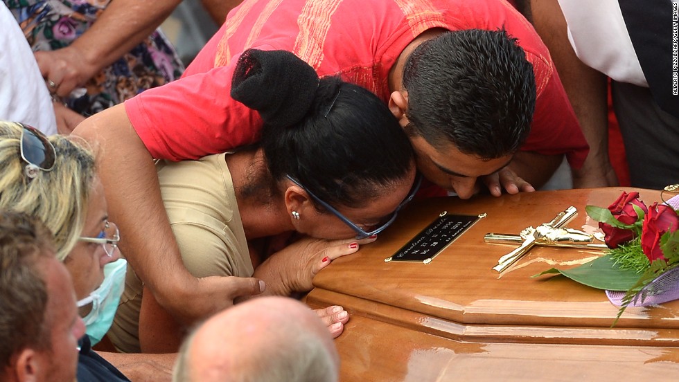 Relatives of a victim kiss a coffin on July 29 near a morgue in Monteforte Irpino. 