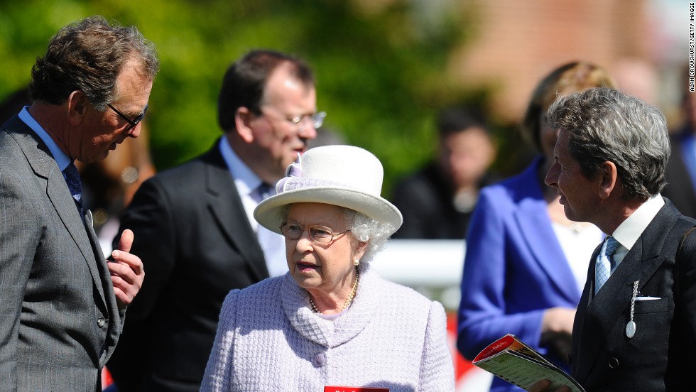 Queen Elizabeth II with her racing manager John Warren (left) and trainer Roger Charlton at Newbury racecourse in April 2013. Her horse Sign Manual was among the winners at the meeting.