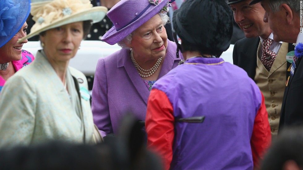 Britain&#39;s monarch shares a private moment with her connections and jockey Ryan Moore after the historic victory in June 2013. Her only daughter Princess Anne, who represented Britain at the 1976 Olympics in equestrian, is to her left. 