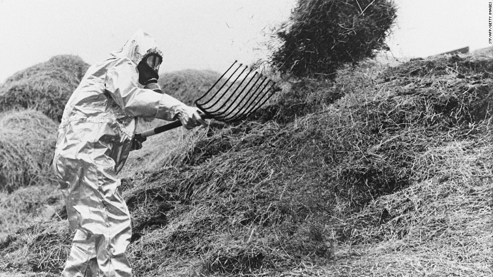 A farmer in Sweden wears a protective suit as he sifts hay possibly contaminated by the radioactive cloud from Chernobyl in June 1986.