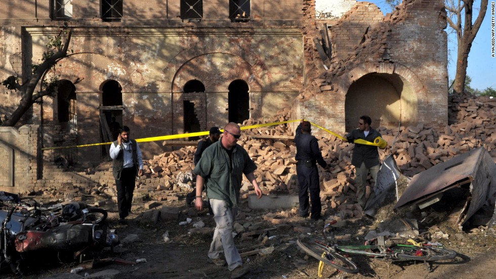 Officials examine the aftermath of a terrorist attack outside the &lt;a href=&quot;http://www.cnn.com/2010/WORLD/asiapcf/04/05/pakistan.blast/index.html&quot;&gt;U.S. Consulate in Peshawar, Pakistan,&lt;/a&gt; on April 5, 2010. The coordinated attack involved a vehicle suicide bomb and attackers who tried to enter the consulate by using grenades and weapons fire. Two consulate security guards and at least six others were killed.