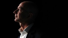 Jeff Bezos, chief executive officer of Amazon.com Inc., watches a video of the new Kindle Fire HD tablet at a news conference in Santa Monica, California, on Sept. 6, 2012. (Patrick Fallon/Bloomberg via Getty Images)