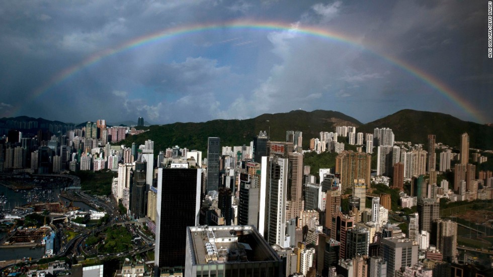 A rainbow appears in the skies above a Hong Kong office building on Wednesday, August 7. Click through to see other images of weather around the world.