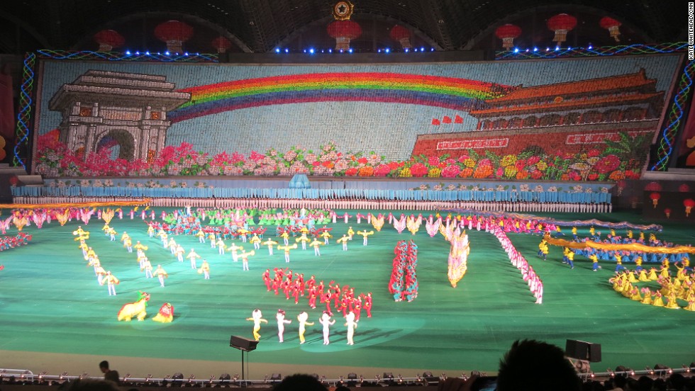 That rainbow-themed backdrop consists of thousands of people holding up different boards. This year they flashed messages of peace and friendship, as well as the rainbow between Pyongyang&#39;s Arch of Triumph and Beijing&#39;s Tiananmen Square Gate, while Lion Dancers, Pandas and Russian Dancers strutted about on stage. 