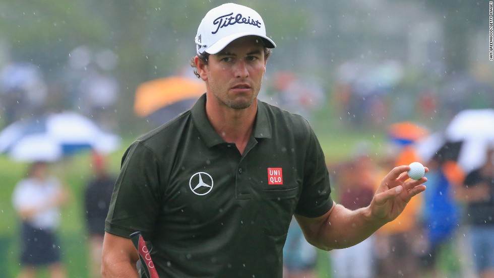 Adam Scott acknowledges the galleries on his way to a second round 68 at a rainy Oak Hill in the second round of the PGA Championship.  