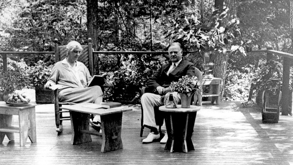 President Herbert Hoover and his wife, Lou Henry, sit on the porch of their Radipan Camp retreat, which is now part of the Shenandoah National Park in Virginia. Hoover originally bought the land for the vacation spot in 1929. 