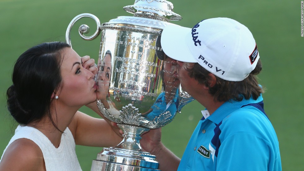 Dufner hugged wife Amanda after clinching victory and the two soon got up close and personal with the winners&#39; trophy. 