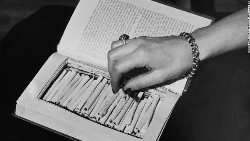Marijuana cigarettes are hidden in a book circa 1940. Congress passed the Marijuana Tax Act in 1937, effectively criminalizing the drug.