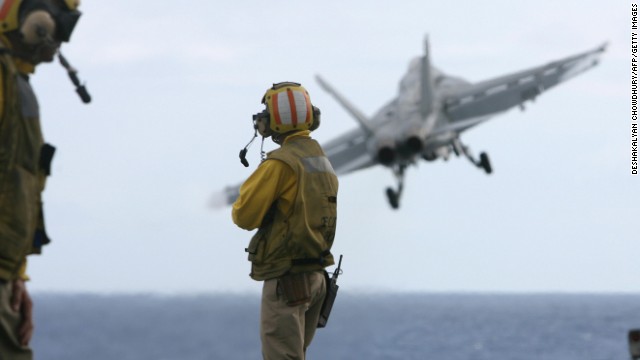 Jets take off from the deck of the USS Nimitz. 