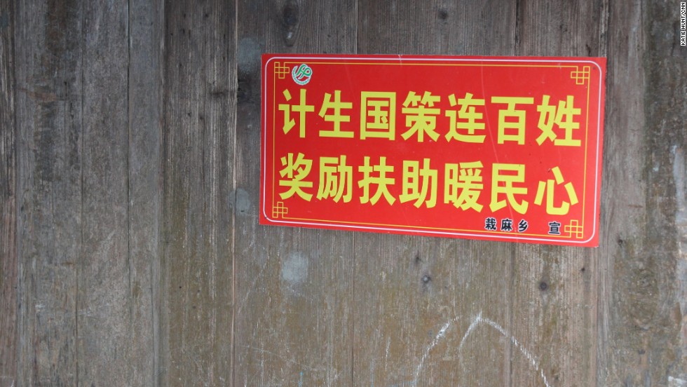 Propaganda slogans are commonplace in Chinese villages to encourage people to comply with government policies. This one reads: State family planning policy connects everyone. Rewards and subsidies warm the heart of the people.&quot;