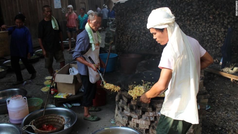 The village marks major events like births and deaths with communal meals cooked in giant woks.
