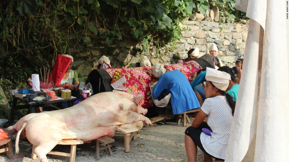 Traditional practices are still observed. After the death of a village elder, female family members wearing white headscarves sit wailing by the coffin wailing and a sacrificed pig.