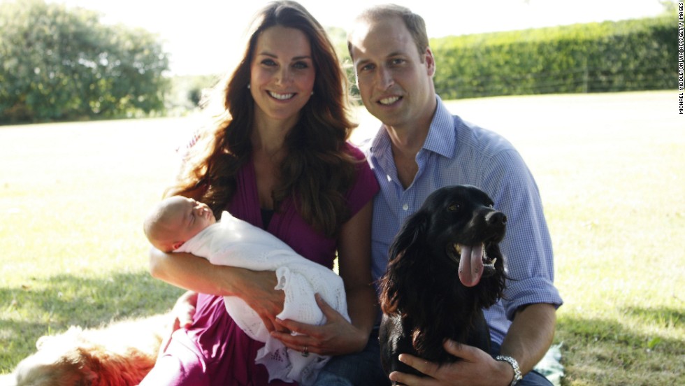 In August, Catherine and William pose with George and their dogs Lupo, right, and Tilly in the garden of Catherine&#39;s family home in Bucklebury, England.