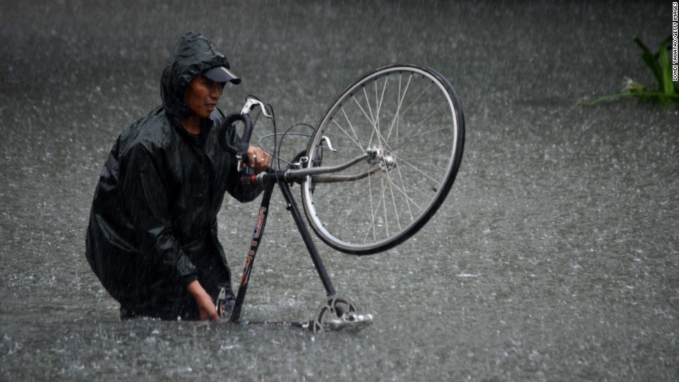 A man guides his bike through flood waters that submerged parts of the financial district of Makati on August 20.