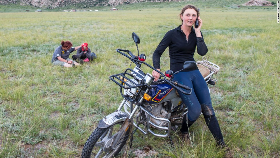 There was heartbreak for American Devan Horn at the finish when she crossed the line first only for her horse to fail its veterinary inspection. Horn (pictured in the background) was given a two-hour penalty, handing victory to Prior-Palmer. In this picture, Prior-Palmer receives a congratulatory phone call while Horn is comforted by a race steward.