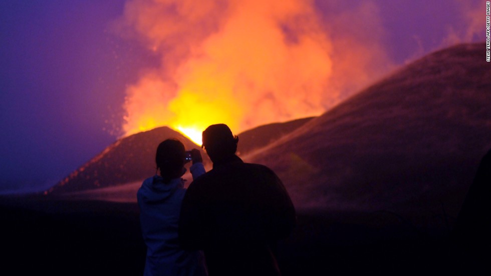 Tampa says Congo has the potential to be a huge tourist attraction, creating jobs and businesses for the region. Tourists take a photo of a volcanic eruption at the Virunga National Park, near Goma.