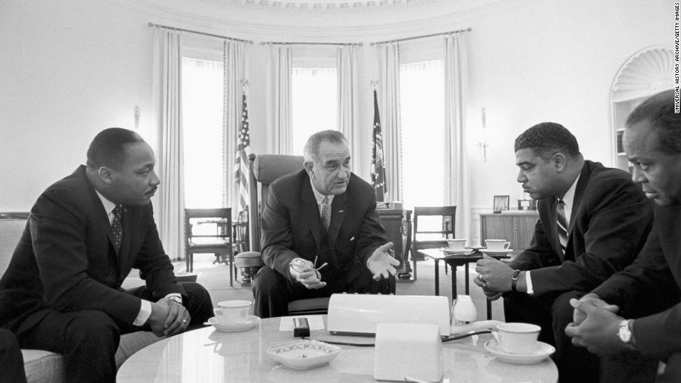 President Lyndon B. Johnson talks with King and civil rights leaders at the White House. On July 2, 1964, Johnson signed the Civil Rights Act into law. 