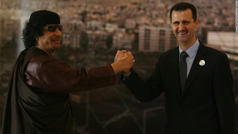 Moammar Gadhafi and al-Assad clasp hands at the opening session of the Arab Summit in Damascus on March 29, 2008.