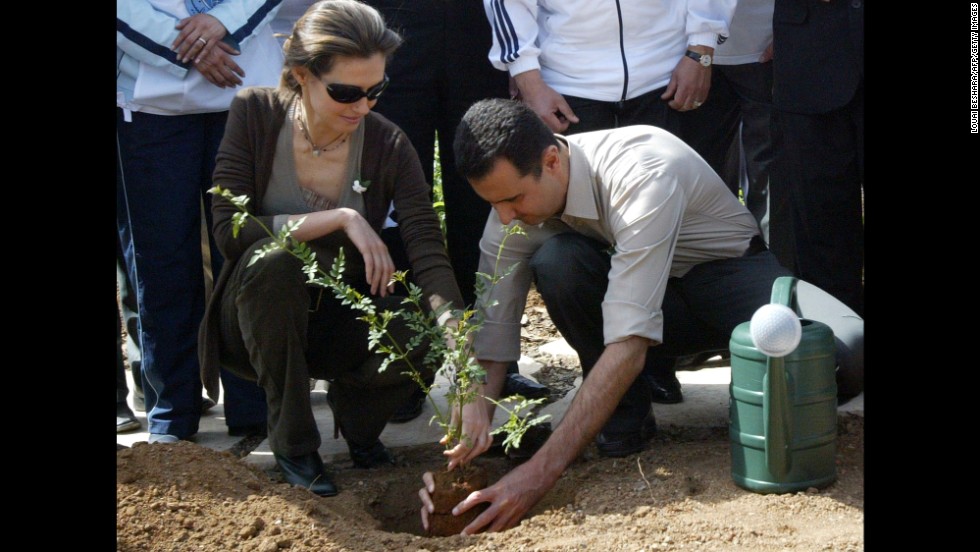 Asma al-Assad plants a jasmine bush with her husband in old Damascus on April 27, 2007. 