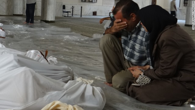 A Syrian man mourns over the bodies of those killed in an alleged chemical weapons attack in Damascus, Syria, in 2013.