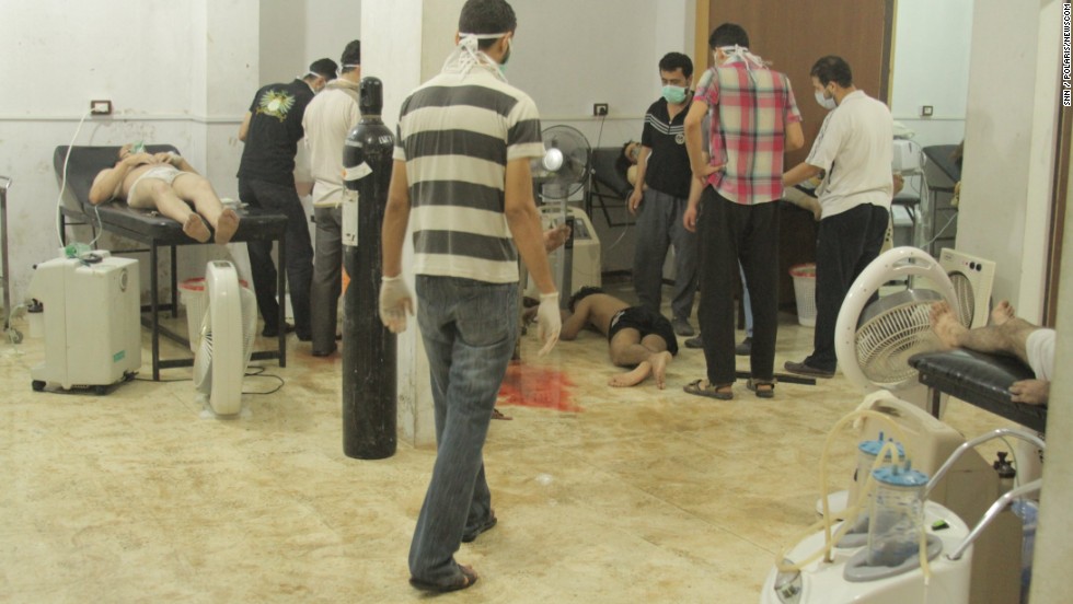 People attend to the victims of the attack on August 21 in Damascus. British intelligence said at least 350 people died, while rebel leaders have put the death toll at more than 1,300. 