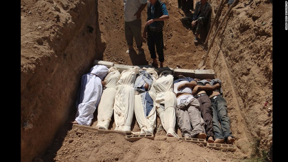 Victims are buried in a suburb of Damascus on August 21. 