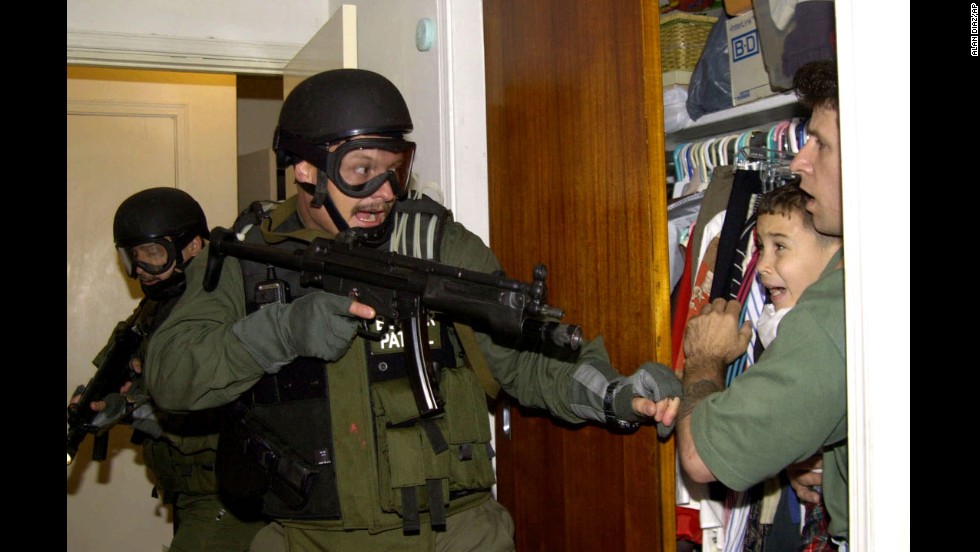 During a raid at a Miami home in 2000, armed federal agents confront Elian Gonzalez, 6, and one of the men who helped rescue the boy. Gonzalez watched his mother drown when the boat smuggling them from Cuba capsized. Under international law, U.S. authorities were required to return the boy to his father in Cuba. Alan Diaz&#39;s photograph of the saga&#39;s defining moment won a Pulitzer Prize. &quot;The cry I heard that day I had never heard in my life,&quot; &lt;a href=&quot;http://articles.sun-sentinel.com/2010-04-22/news/fl-elian-photographer-20100422_1_cry-elian-gonzalez-haunted&quot; target=&quot;_blank&quot;&gt;Diaz said a decade later&lt;/a&gt;. &quot;A cry like that will haunt anyone forever.&quot;