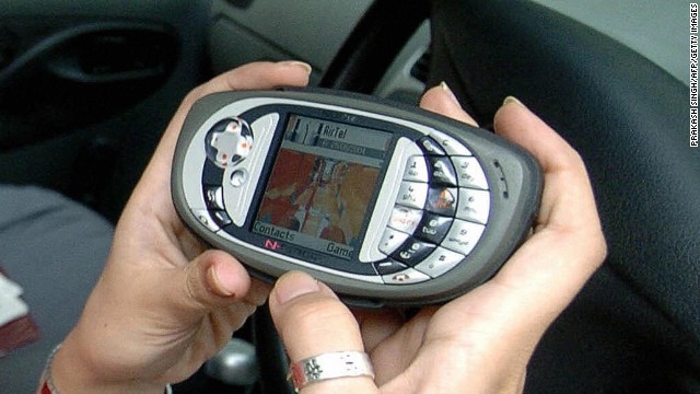 An Indian public relations representative Rowena shows a new Nokia N-Gage QD game deck mobile telephone handset as she plays a game in her car in New Delhi, 25 June 2004. Nokia N-Gage QD handset has 3.4 MB internal user memory,16 MB SD ram, Blue Tooth and a HTML browser.