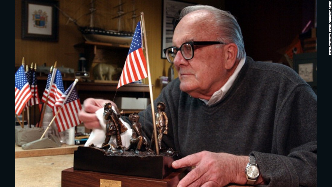 Artist Jim Conrad designed a sculptured bronze version of the flag raising in honor of the Rev. Mychal Judge, a New York Fire Department chaplain who lost his life while administering last rites on September 11, 2001. Conrad is seen polishing the sculpture in 2002 at his home in Lakewood, Colorado.