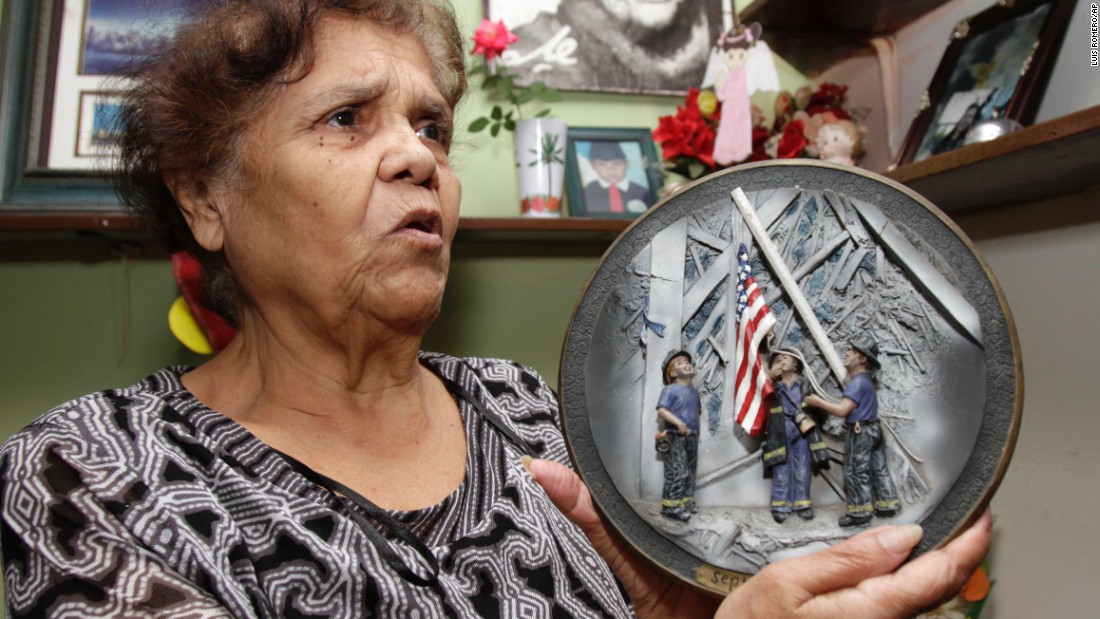 A woman holds a commemorative plate at her home in San Salvador, El Salvador, on September 7, 2011.