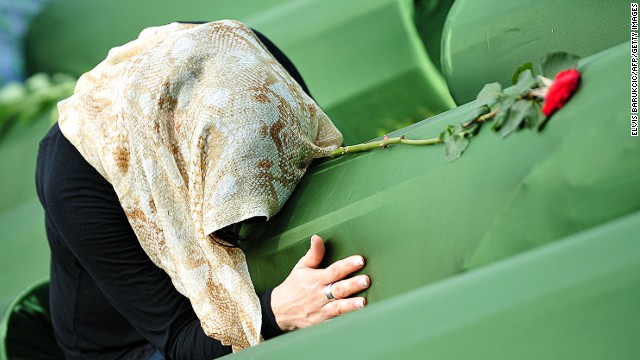 A survivor of Srebrenica 1995 massacre, mourns for her relatives at a cemetery in Potocari, Bosnia, on July 11, 2013.