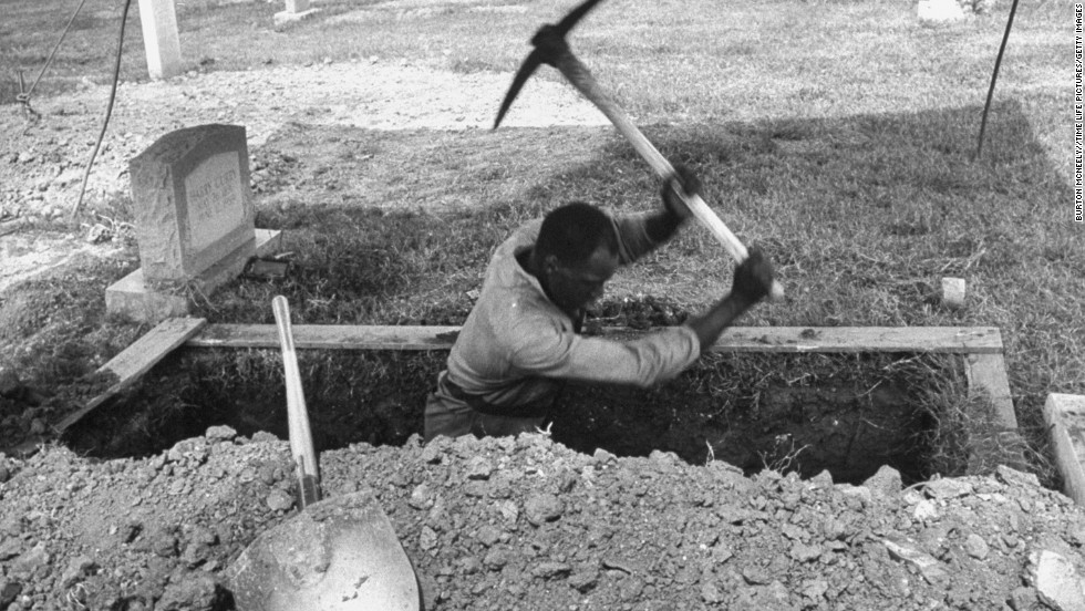 A man digs a grave for one of the girls.